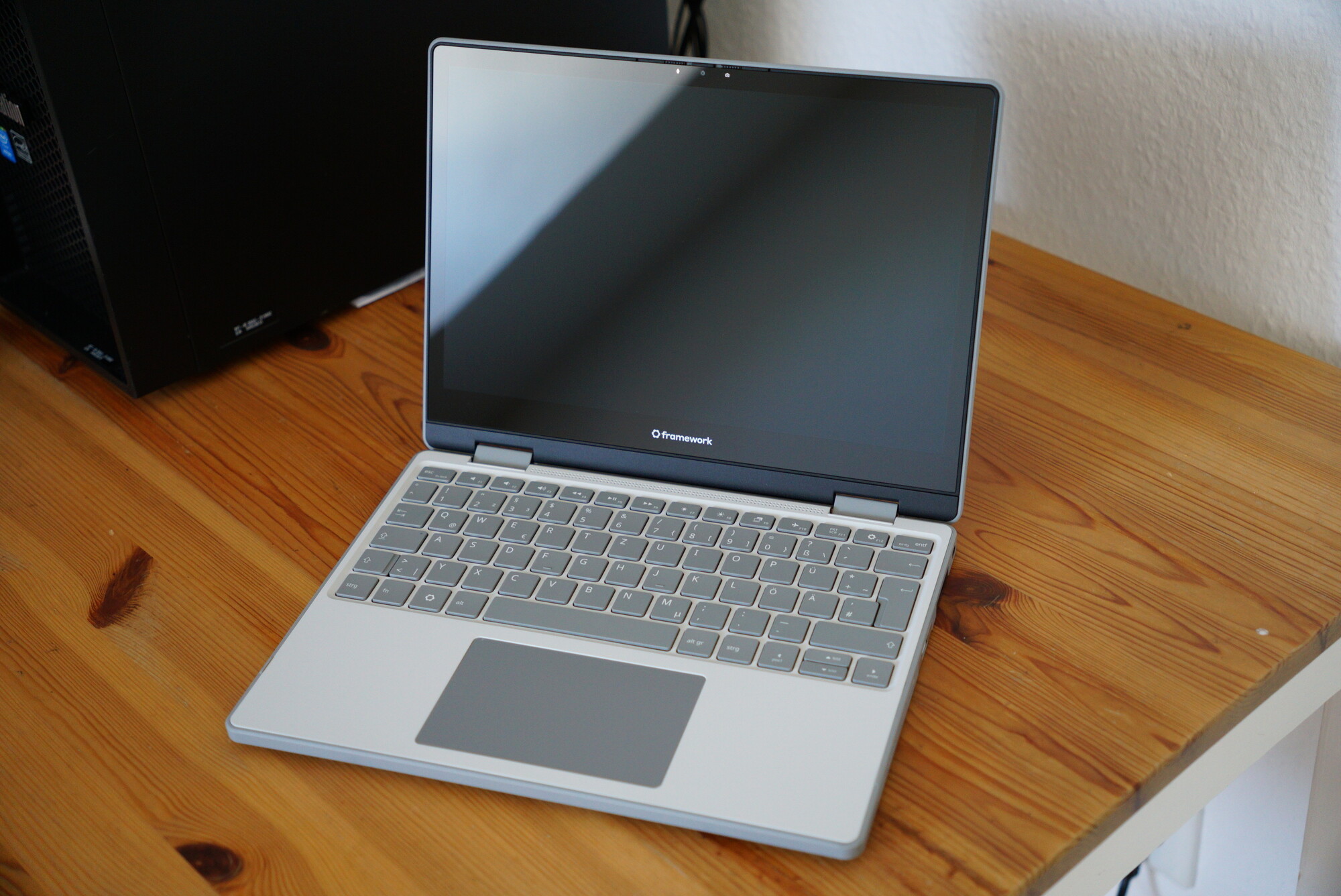 A photo of an opened Framework 12 laptop standing on a desk.